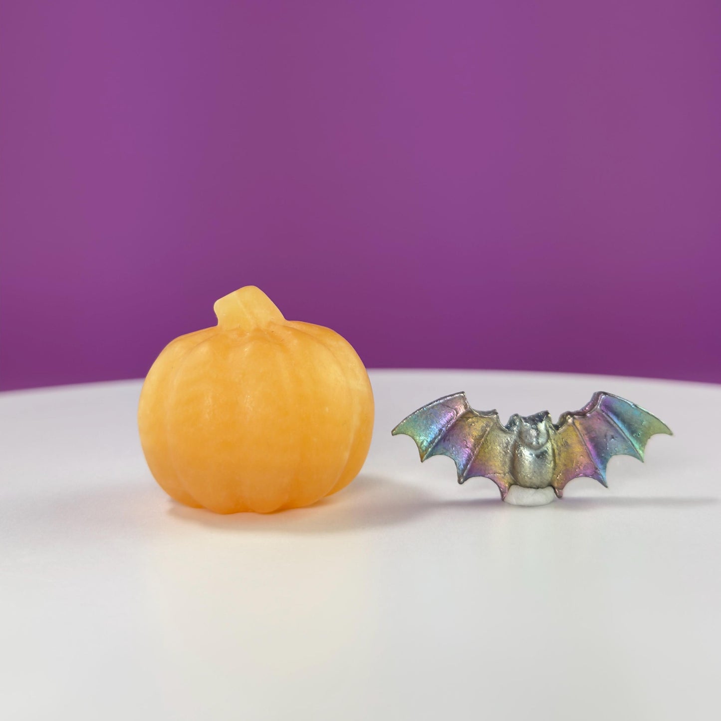 Orange Calcite Pumpkin and Aura Bismuth Bat Carvings