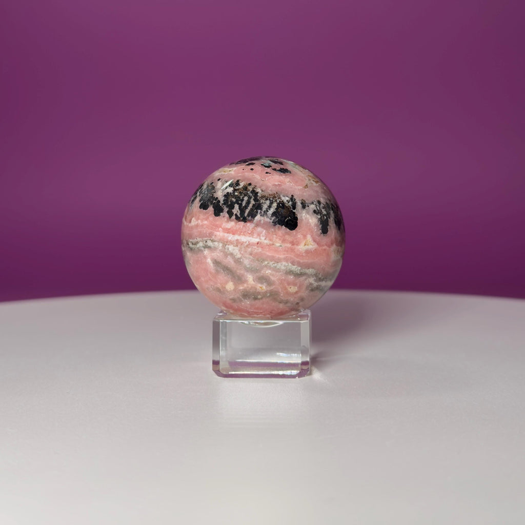 Rhodonite Sphere with Glass Stand – 144g Pink and Black Crystal for Emotional Healing