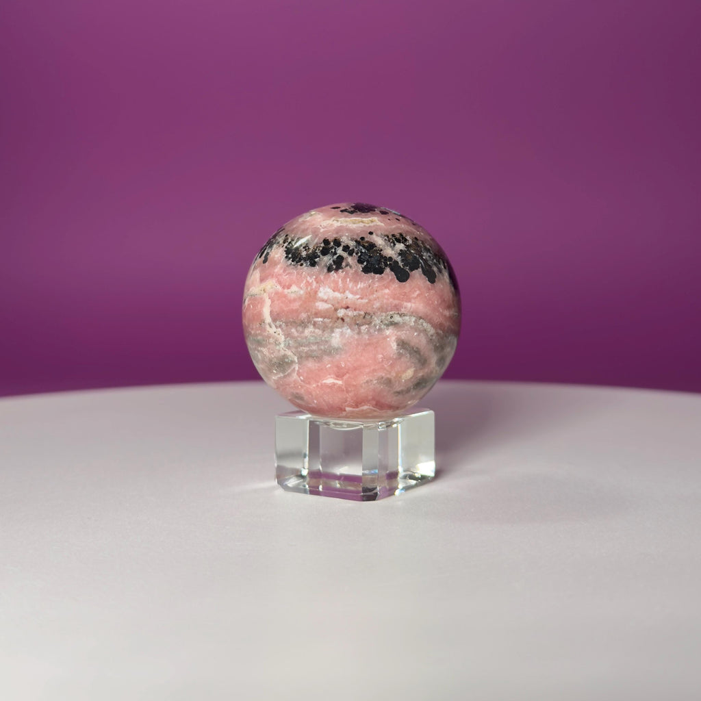 Rhodonite Sphere with Glass Stand – 144g Pink and Black Crystal for Emotional Healing