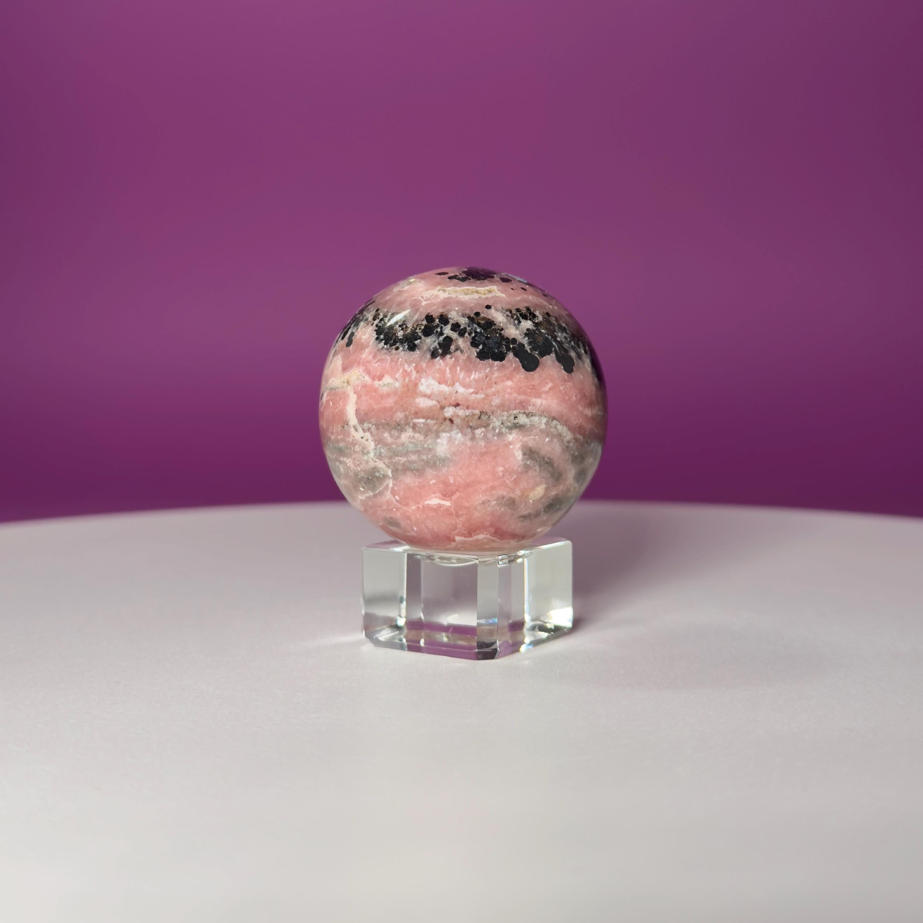 Rhodonite Sphere with Glass Stand – 144g Pink and Black Crystal for Emotional Healing