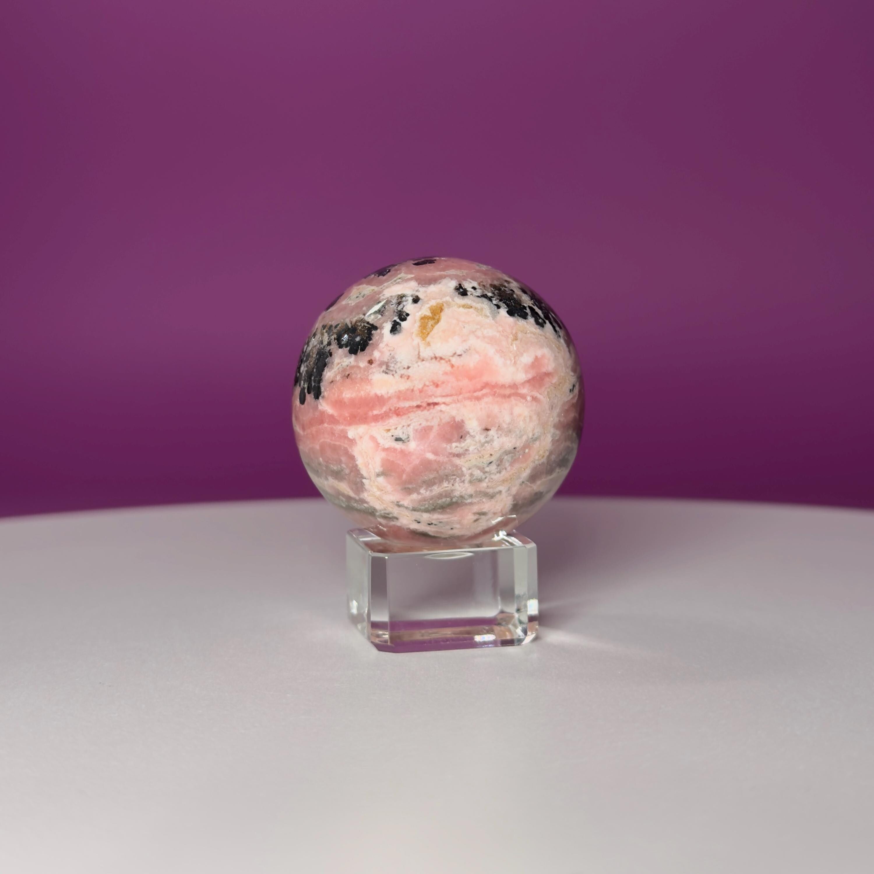 Rhodonite Sphere with Glass Stand – 144g Pink and Black Crystal for Emotional Healing