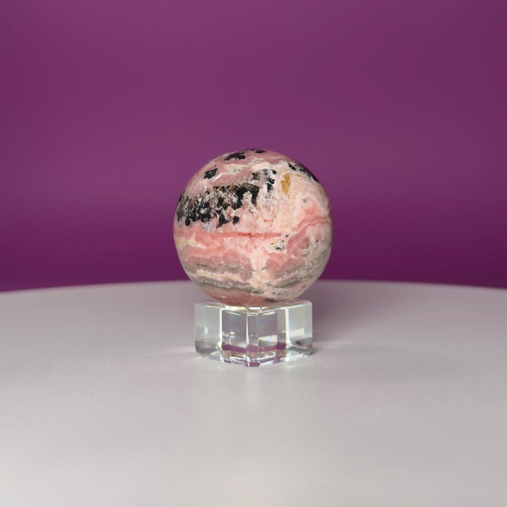 Rhodonite Sphere with Glass Stand – 144g Pink and Black Crystal for Emotional Healing