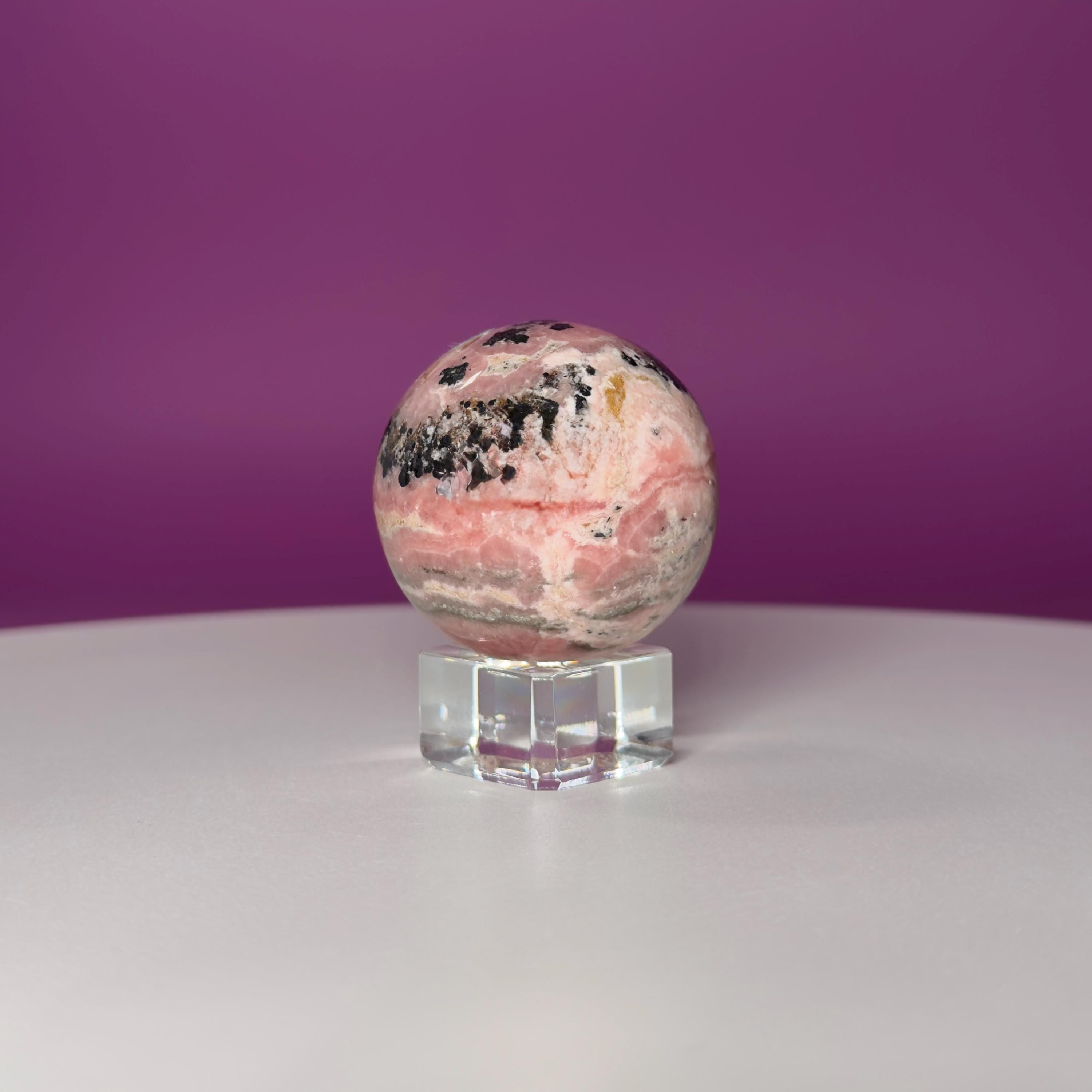 Rhodonite Sphere with Glass Stand – 144g Pink and Black Crystal for Emotional Healing