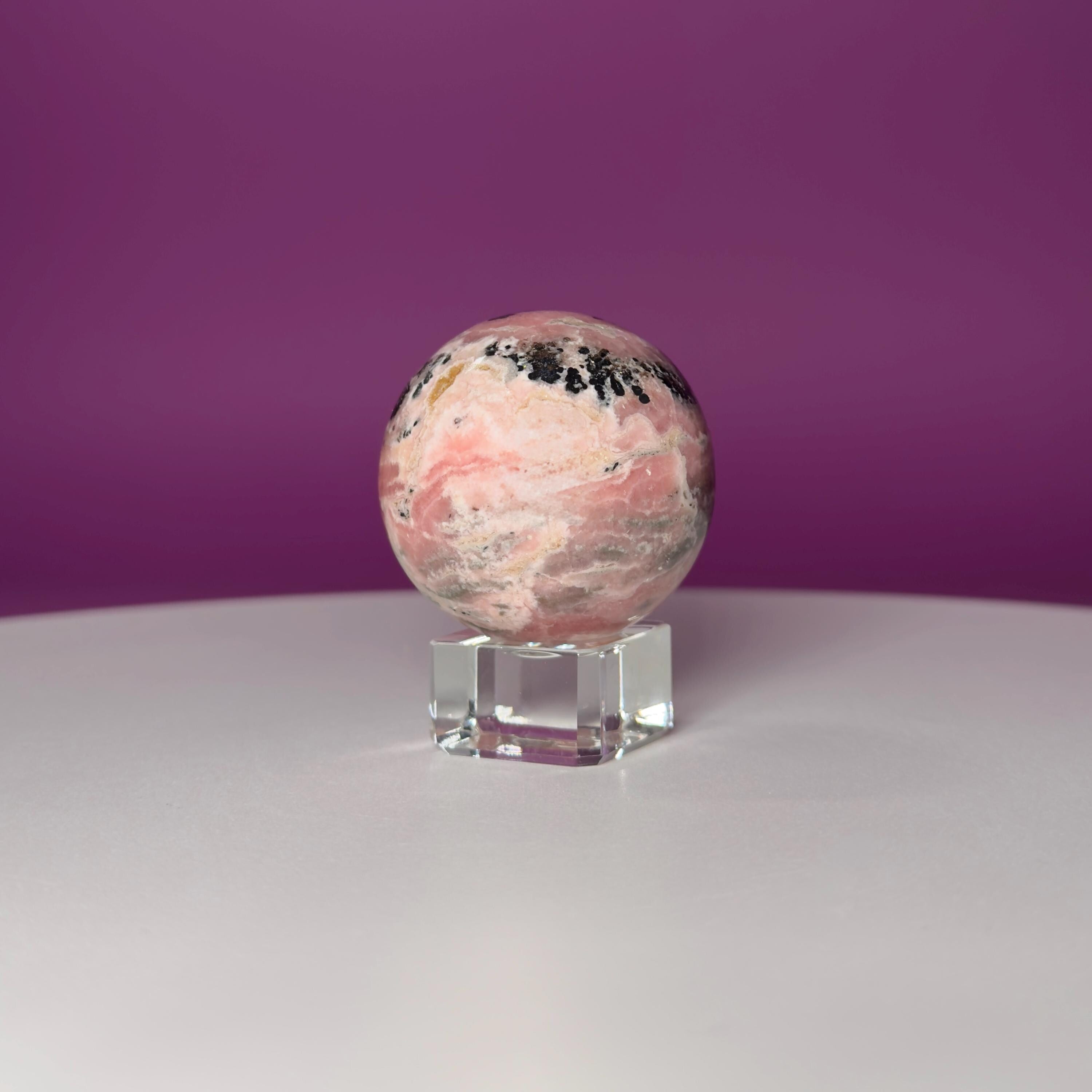 Rhodonite Sphere with Glass Stand – 144g Pink and Black Crystal for Emotional Healing