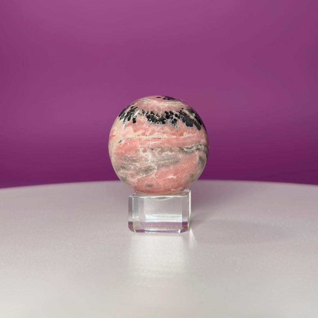 Rhodonite Sphere with Glass Stand – 144g Pink and Black Crystal for Emotional Healing