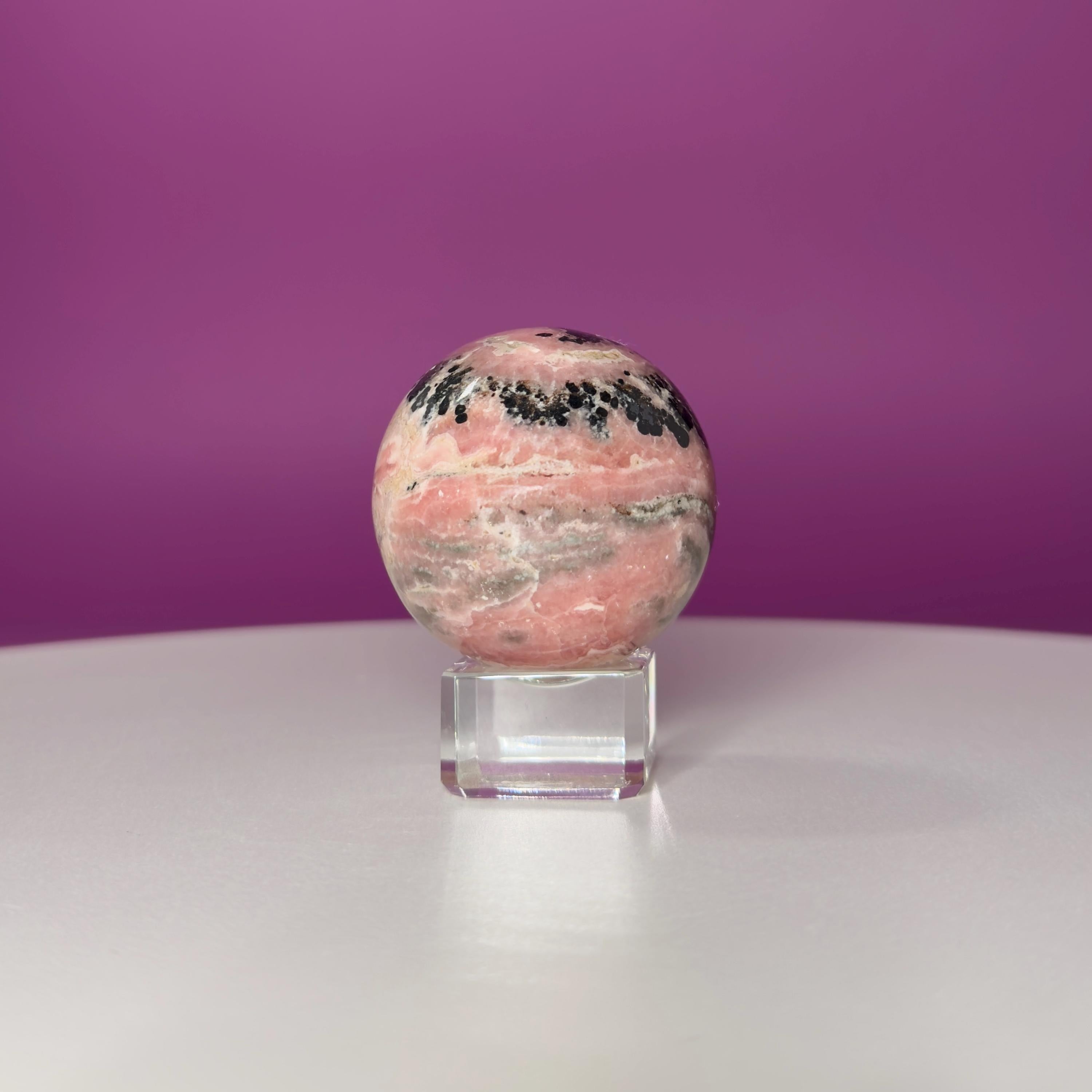 Rhodonite Sphere with Glass Stand – 144g Pink and Black Crystal for Emotional Healing