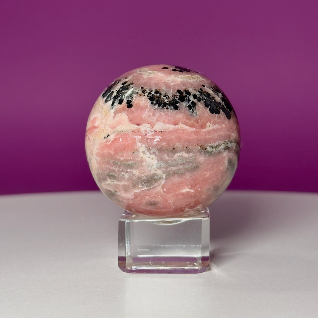 Rhodonite Sphere with Glass Stand – 144g Pink and Black Crystal for Emotional Healing