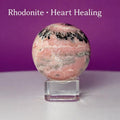 Rhodonite Sphere with Glass Stand – 144g Pink and Black Crystal for Emotional Healing