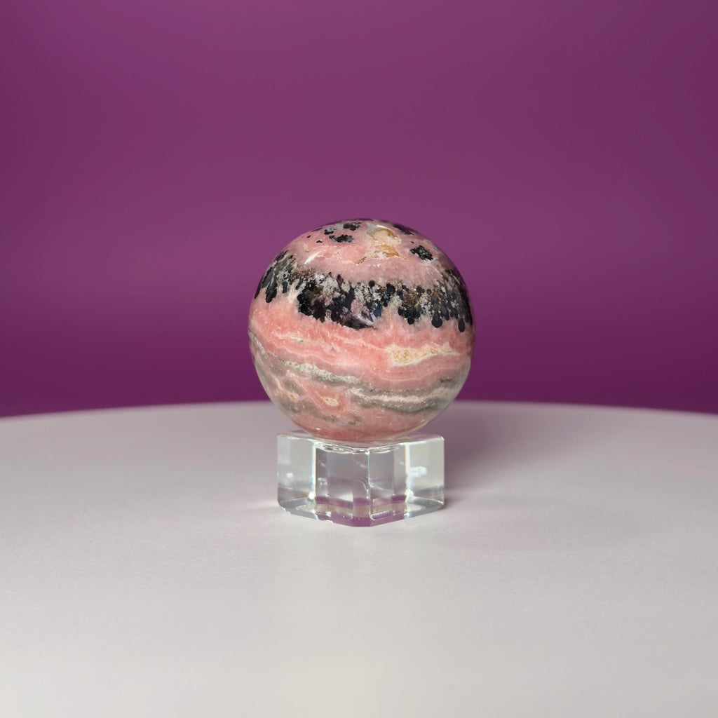 Rhodonite Sphere with Glass Stand – 144g Pink and Black Crystal for Emotional Healing