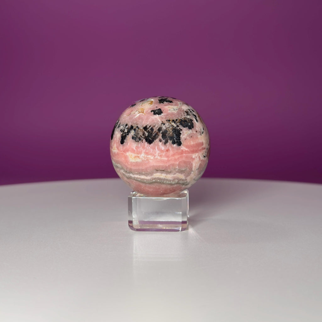 Rhodonite Sphere with Glass Stand – 144g Pink and Black Crystal for Emotional Healing