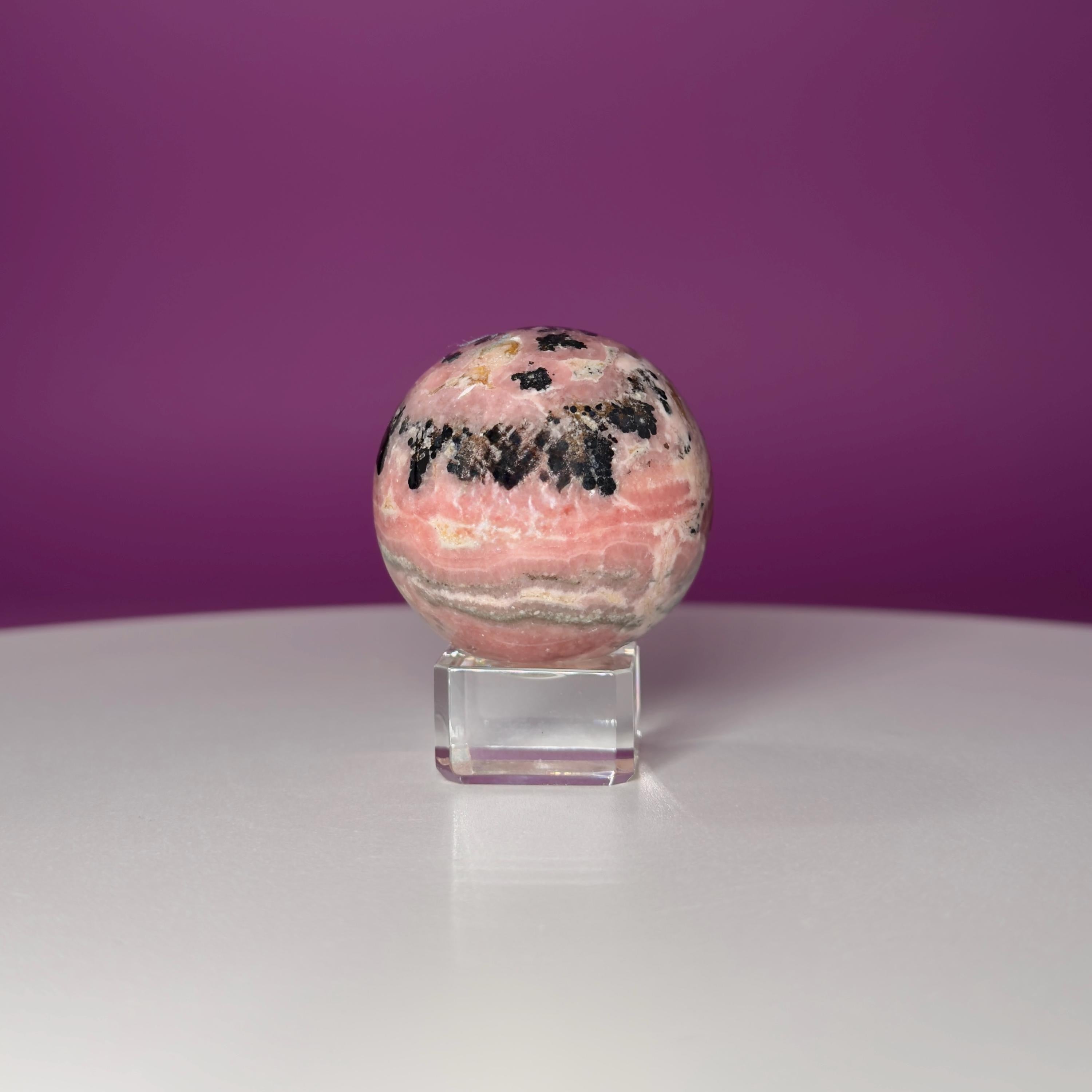Rhodonite Sphere with Glass Stand – 144g Pink and Black Crystal for Emotional Healing